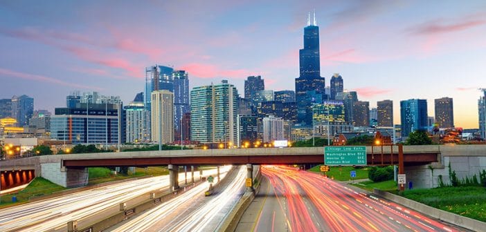 Chicago downtown skyline at twilight with highway and traffic.