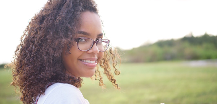 The Comprehensive Guide for Financing Your Very First Real Estate Deal 4 dark curly haired pretty woman in glasses smiling outdoors