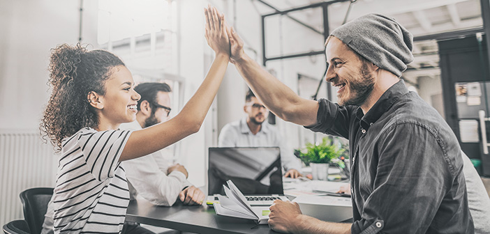 Business people happy showing team work and giving five in office. Teamwork concepts.