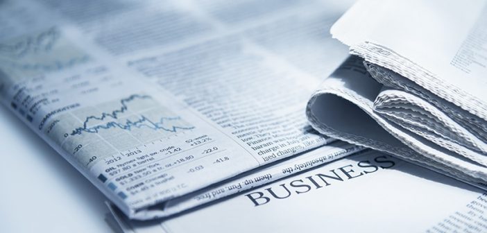 closeup of folded stacked newspaper with business section visible