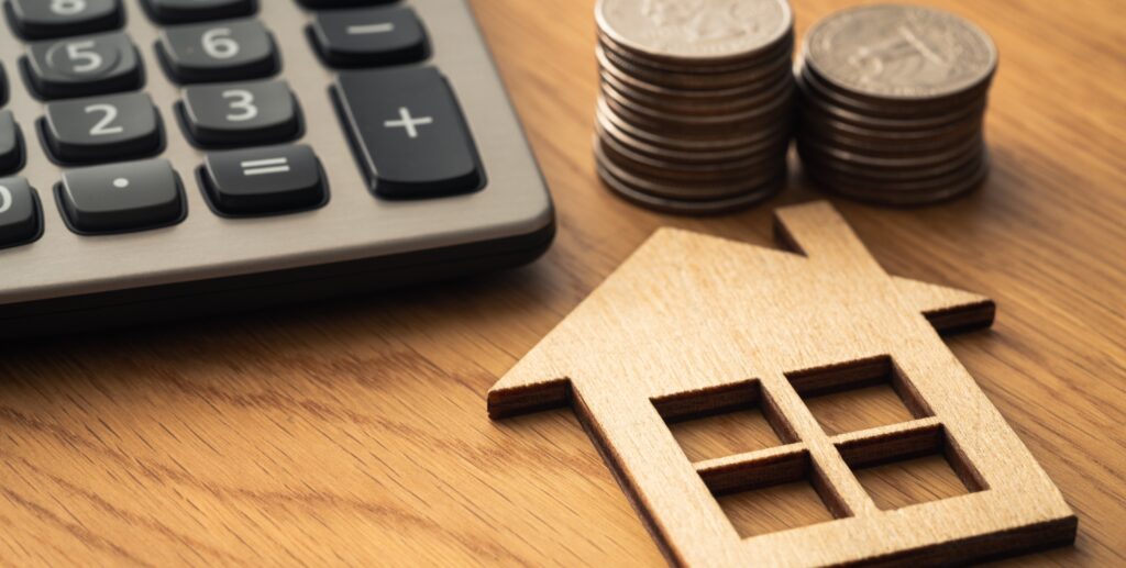 Hard Money Loans: The Costs And Benefits 1 house cutout next to calculator