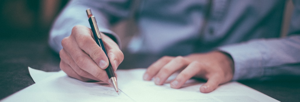 Guide to Real Estate Contracts 1 person signing a real estate contract